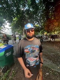 a man wearing a t - shirt in a park