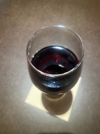 a glass of red wine on a table