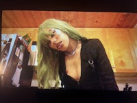 a woman with green hair in a kitchen