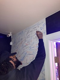 a man writing on the wall of a room