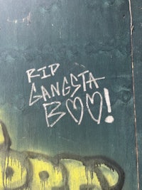 graffiti on a wall that says rip gangsta boo