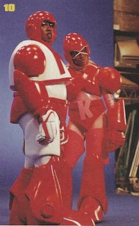 two men in red suits standing next to each other