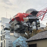 a building with a red and white building on top of it