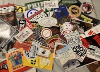 a collection of various stickers on a bed